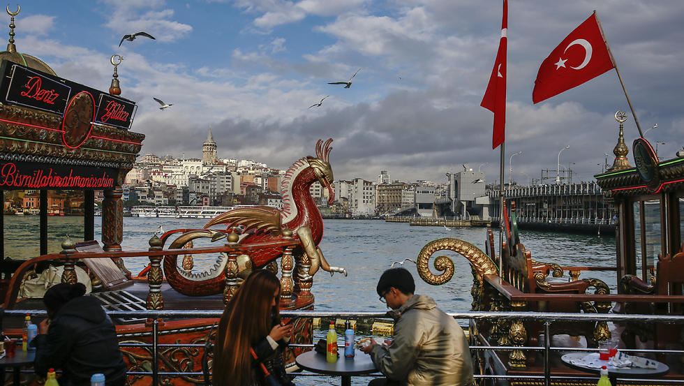 People sit in a coffee shop in Istanbul's Eminonu district by the Golden Horn. (Photo: AP)