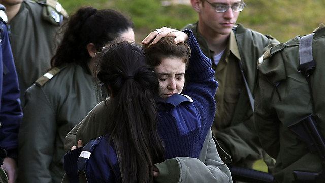 Soldiers comforting one another at the scene of the attack (Photo: AFP)