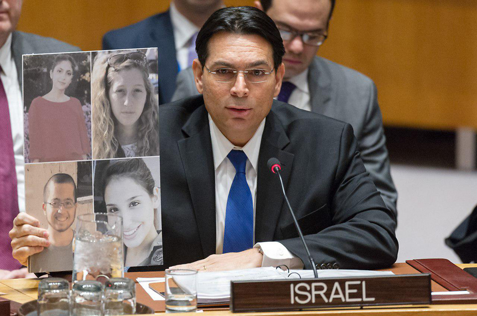 Danon holds picture of four Israelis killed in last week's attack