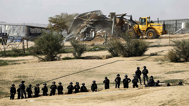 Police form a human chain as demolition underway (Photo: AFP)