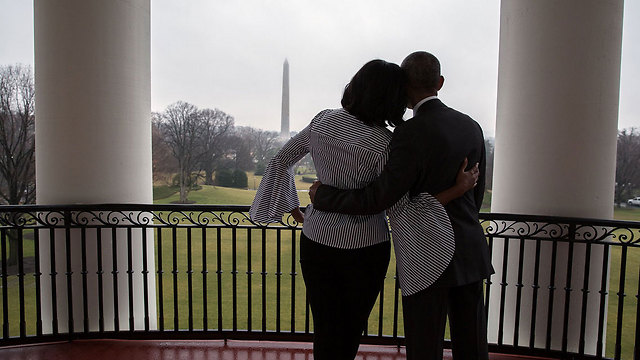 חיבוק אחרון על מרפסת הבית הלבן. בני הזוג אובמה צופים על אנדרטת וושינגטון ()