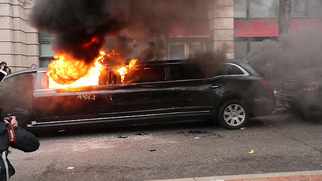 Burning a limo in DC (Photo: AFP)