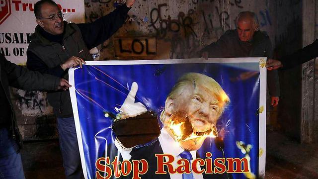 Palestinians burn a Trump poster outside of Bethlehem