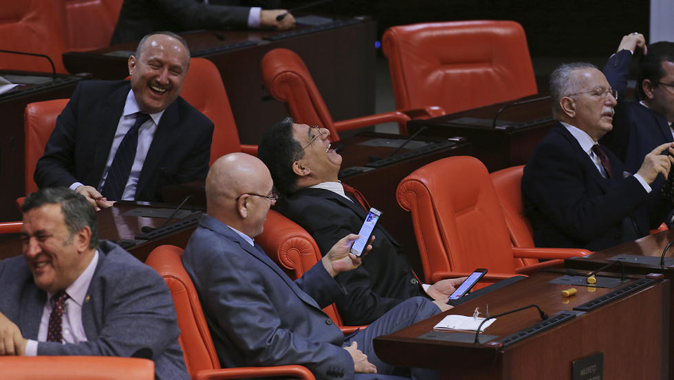 Turkey's opposition Nationalist Movement Party, or MHP legislators, who declared that they voted 'No' , laugh during Turkey's parliament debate (Photo: AP)