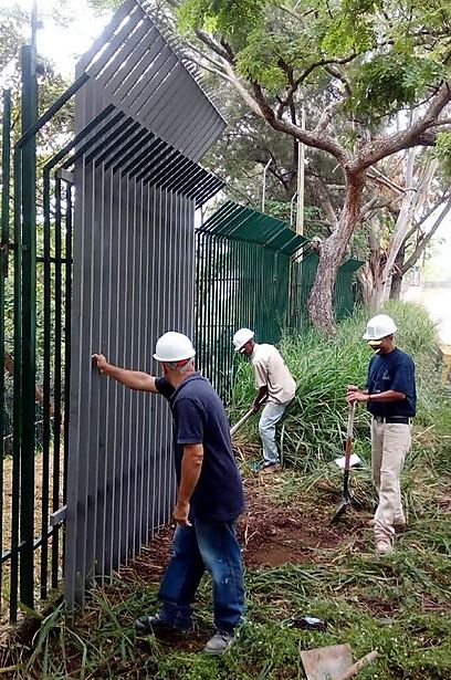 Installation of a tall fence in South American Jewish community