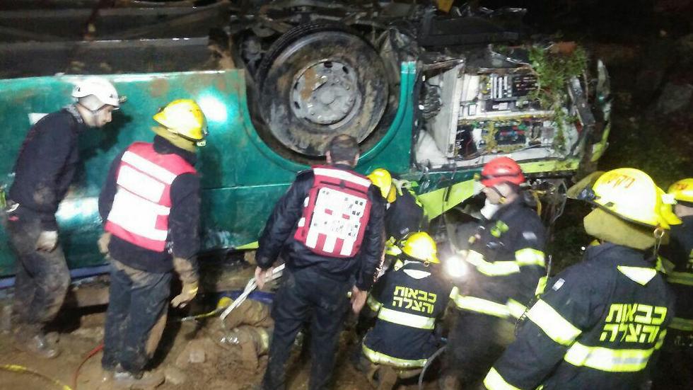 The upturned bus (Photo: Judea and Samaria Fire Fighting and Rescue Unit)