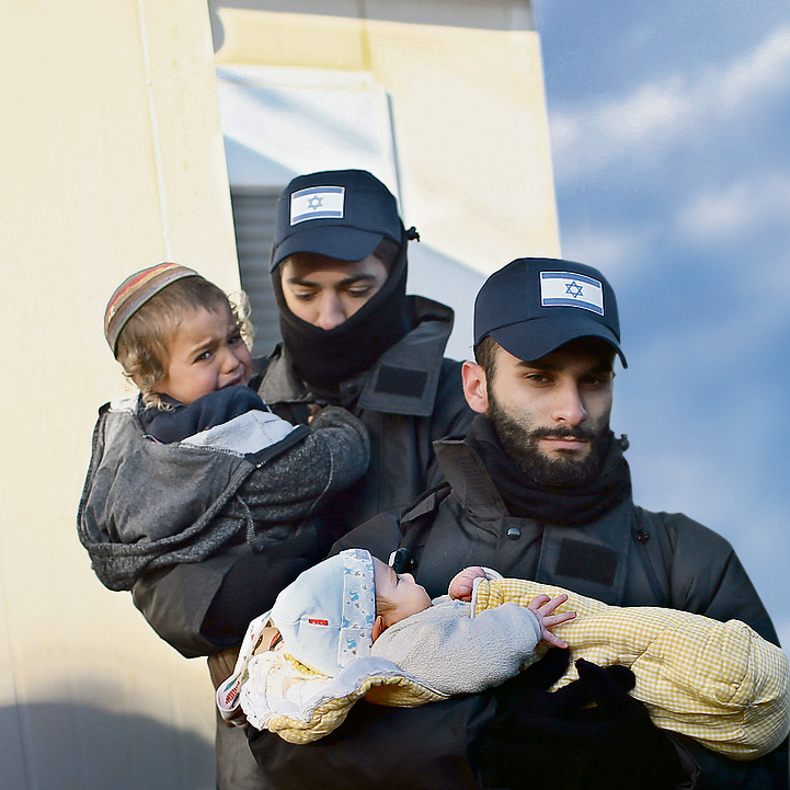 Baby Moshe and his brother, 4-year-old Yossef held by police officers