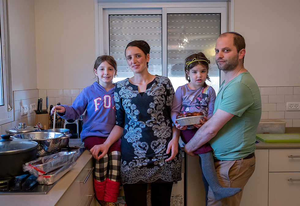 Esther and Netzah Brot with two of their children at their home in Ofra (Photo: Ohad Zwigenberg)