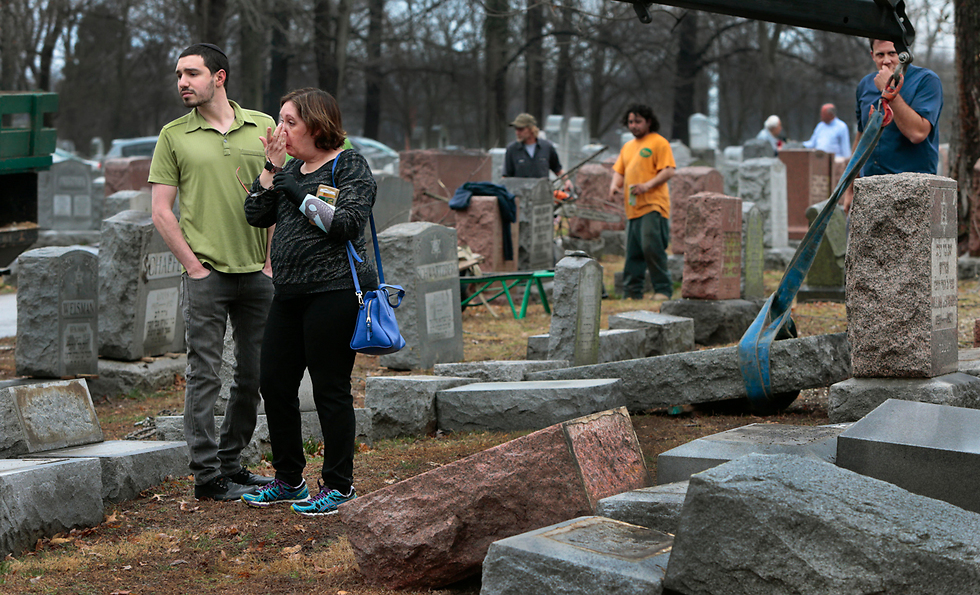 Family members visit the vandalized gravesite (Photo: AP)