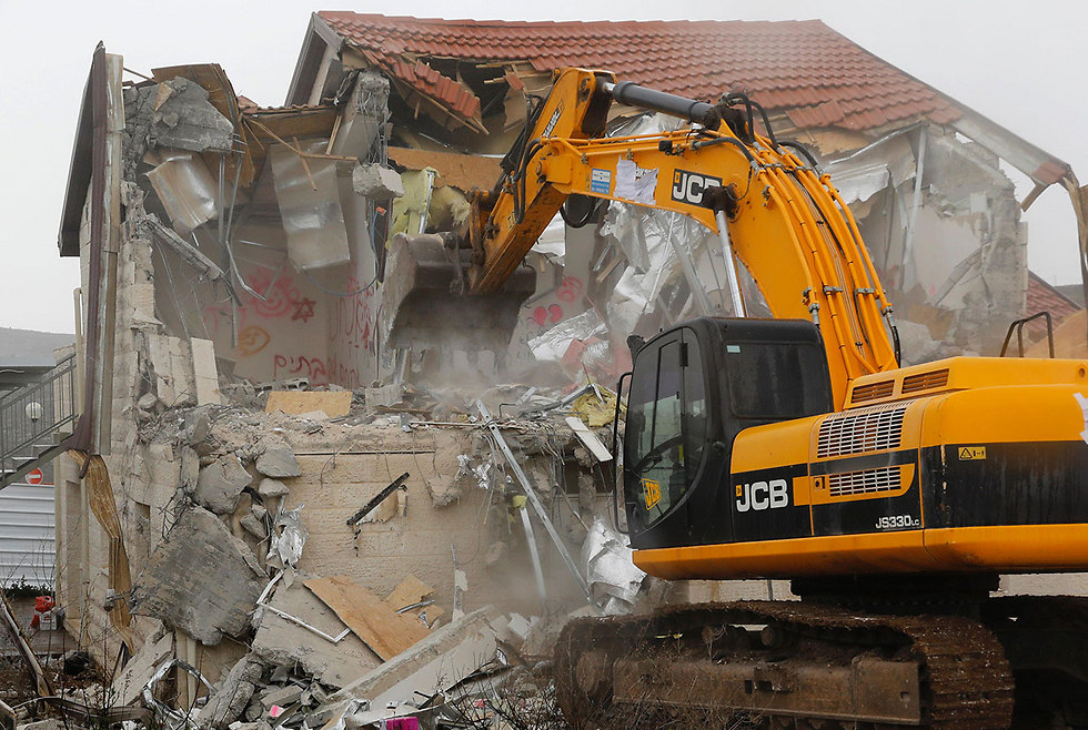 Ofra home being demolished (Photo: AFP)