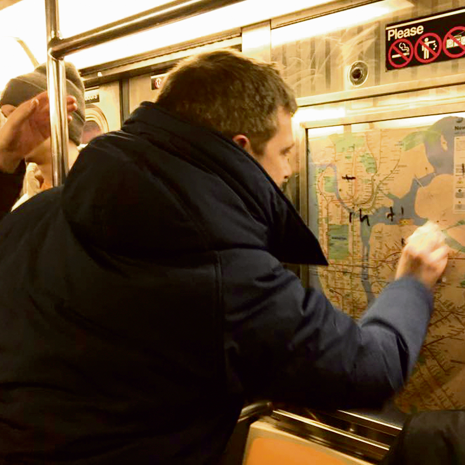 Erasing anti-Semitic graffiti on the NY subway train (Photo: Gregory Locke)