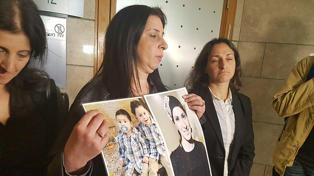 Ravit Crasanti, holding the pictures of her late daughter and two grandsons (Photo: Ahiya Raved)