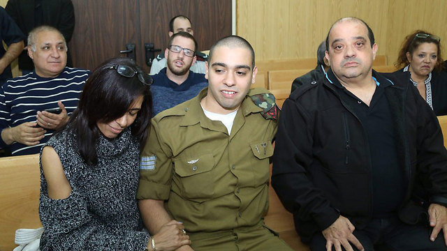 Azaria with his parents in court (Photo: Motti Kimchi)