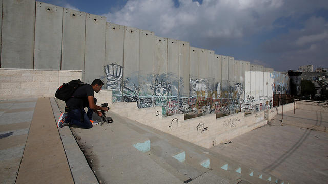 Filming near a section of the Israeli security barrier in Aida refugee camp (Photo: Reuters)