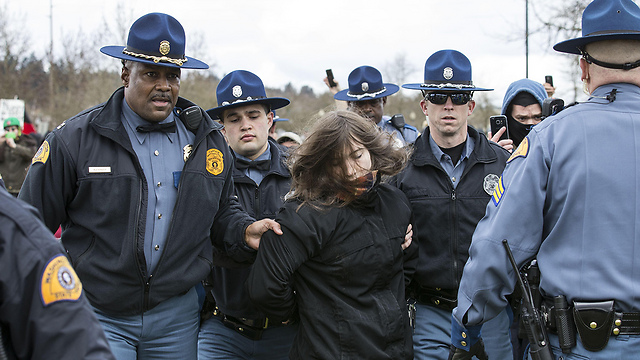 Protester arrested in Olympia (Photo: AFP)