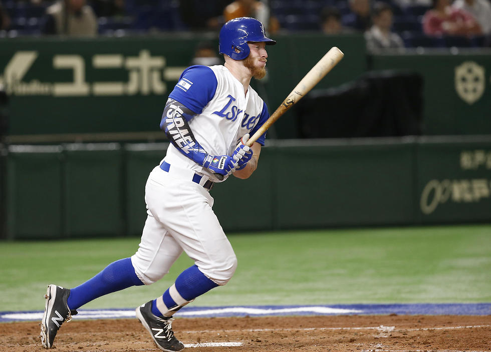 Israel's Zach Borenstein watches the ball while hitting an RBI single against Cuba during the sixth inning (Photo: AP)