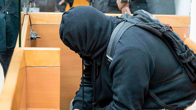 Suspect's father attempting to hide himself from press (Photo: AFP) (Photo: AFP)