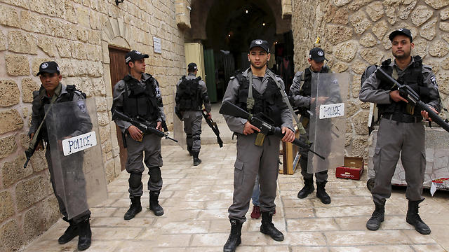 Actors dressed as Israeli border policemen stand during a shoot. (Photo: AP)