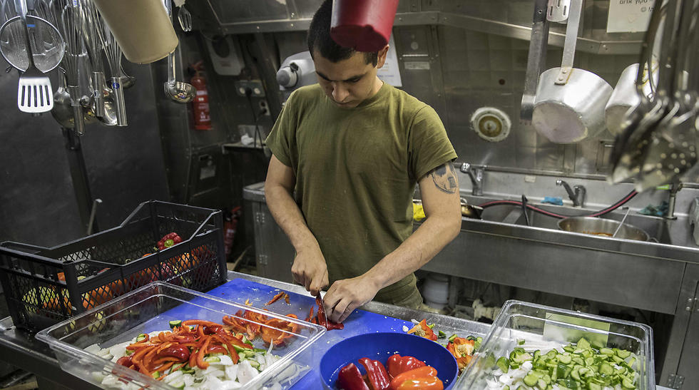 An Israeli sailor onboard the INS Hanit prepares food. (Photo: AFP)