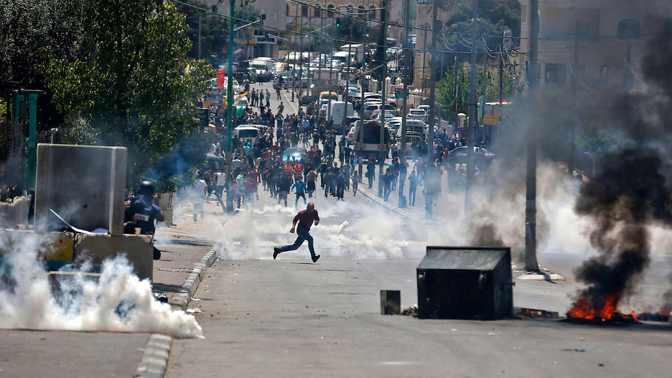 Palestinian protesters hurl stones towards Israeli security forces during clashes following a demonstration in the West Bank town of Bethlehem. (Photo: AFP)