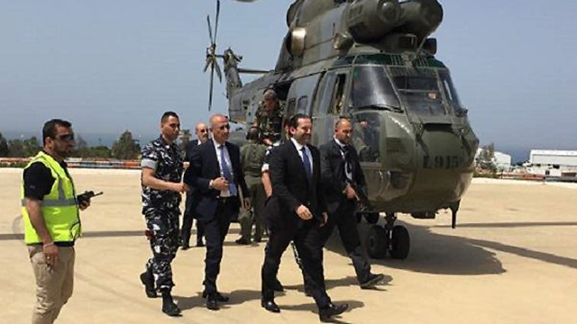 Hariri stepping off a helicopter on his way to a tour of south Lebanon