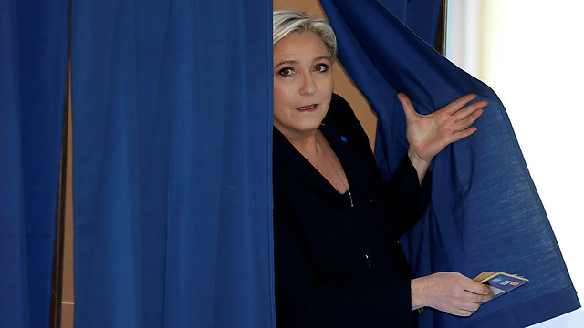Le Pen exiting the voting booth (Photo: Reuters)