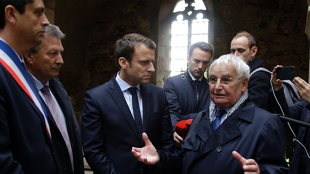 Emmanuel Macron (2nd L), flanked by Mayor of Oradour-sur-Glane Philippe Lacroix (L), listens to Robert Hébras (R), one of the survivors of the Oradour-sur-Glane massacre. (Photo: AFP) 