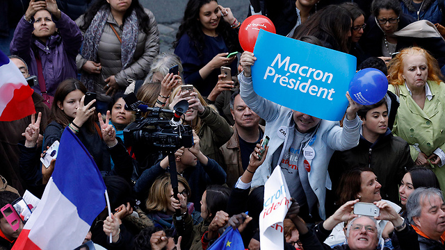 Macron supporters erupting in cheer at news of his projected win (Photo: AP)