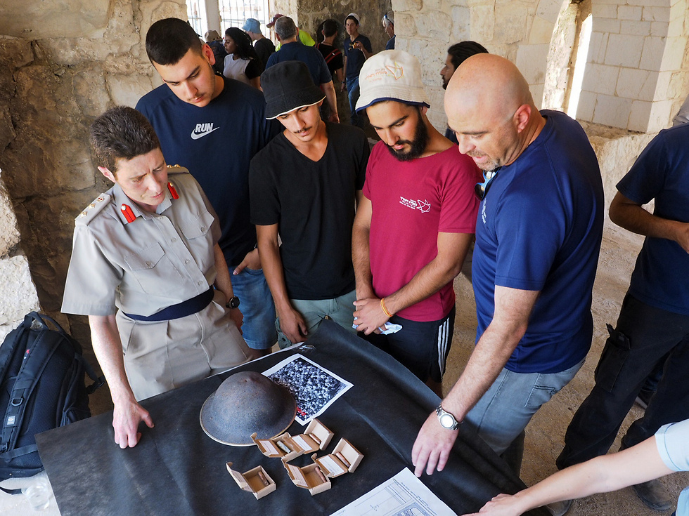 Students of the Melach Ha-Aretz preparatory program and representatives of the Israel Antiquities Authority presented the finds to the British Embassy's defense attaché in Israel, Colonel Ronnie Westerman. (Photo: Assaf Peretz, IAA)