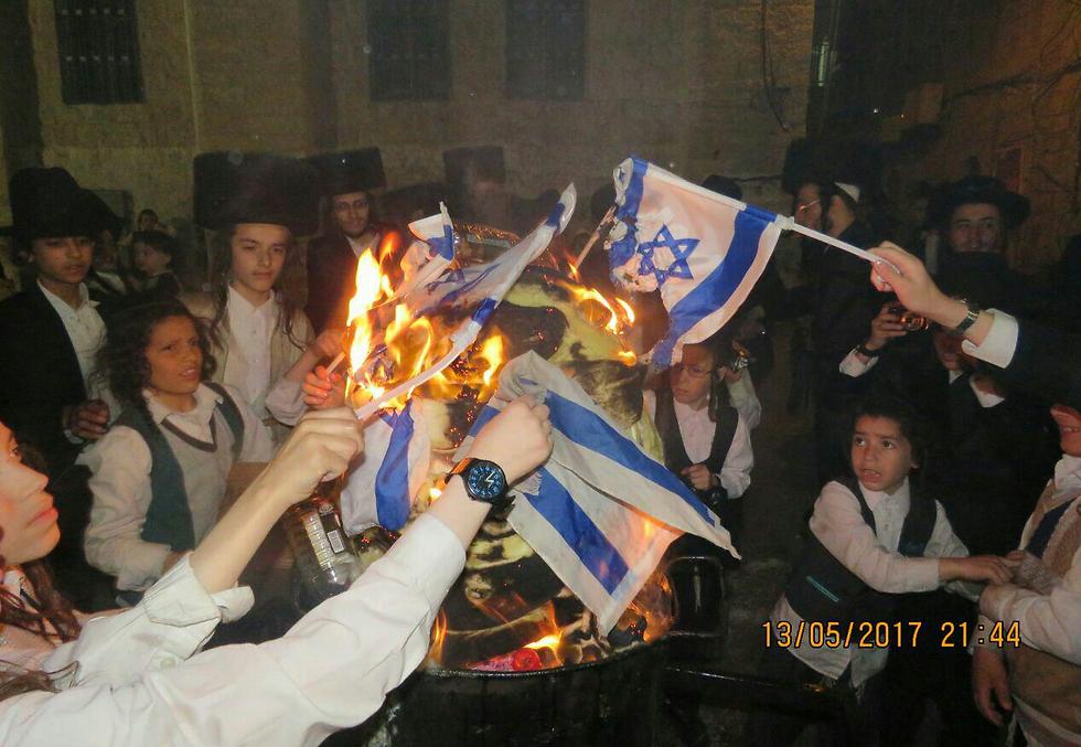 Ultra-Orthodox "Jerusalem Faction" members burning the Israeli flag in protest of the Conscription Law (Photo: Chaim Goldberg)