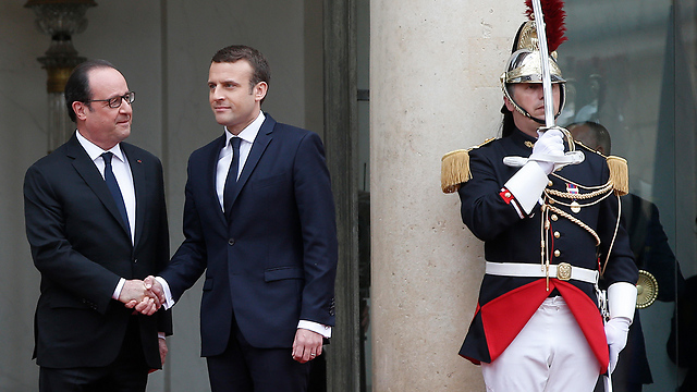 Macron and former-President Hollande shake hands following their meeting (Photo: AP) (Photo: AP)