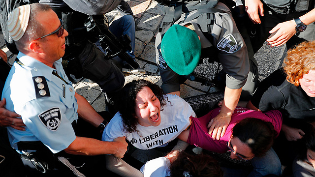 Pro-Palestinian protestor being evacuated by police (Photo: AFP)