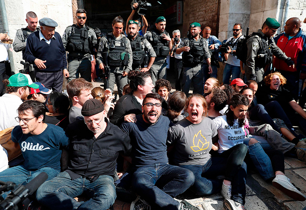 Pro-Palestinian protestors lock arms and chant (Photo: AFP)