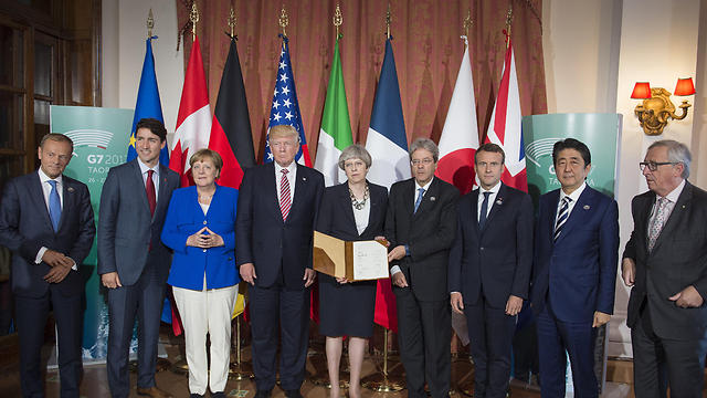Trump (fourth from left) and Gentiloni (fourth from right) with other NATO leaders during summit (Photo: Reuters)