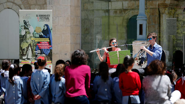 Musicians perform in front of Palestinian schoolchildren during a festival organized by musician Ramzi Aburedwan in east Jerusalem. (Photo: AFP)