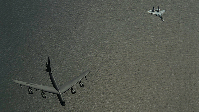 A Russian Su-27 (R) and a US B-52