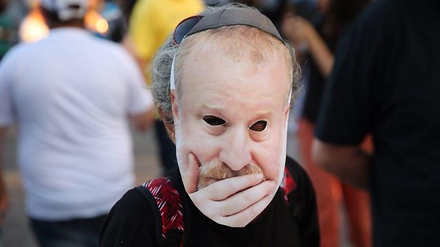Protestor wearing a mask of the AG (Photo: Motti Kimchi)