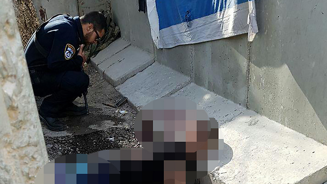 A Border Police officer over the body of the Palestinian attacker