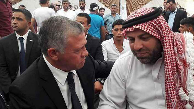 Jordan’s King Abdullah with the father of the killed youth. The Israeli guard’s immunity issue is troubling both government ministers and the angry protestors   