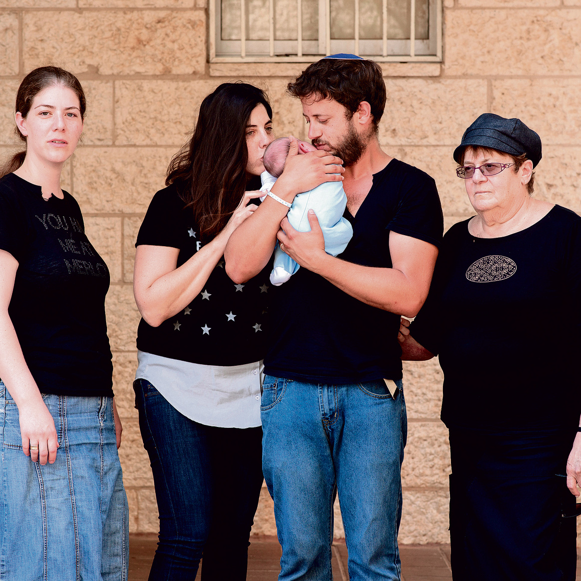 From right to left: Tova Salomon, who lost her husband and two children, her son Shmuel with his wife Chen and baby Ari Yosef, and her daughter-in-law Michal, Elad's widow (Photo: Yuval Chen)