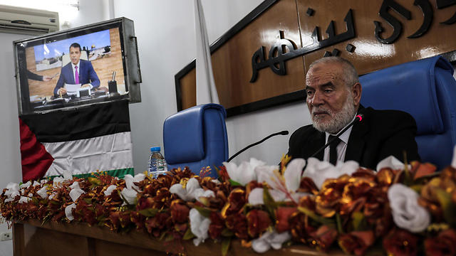 Hamas' MP and head of parliament in Gaza Ahmad Bahar chairs Palestinian legislative Council meeting, as former senior Fatah member Mohammed Dahlan attends meeting via Skype call from United Arab Emirates (Photo: AFP)