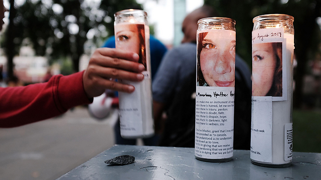 Candles adorned with the face of Heather Heyer, the Charlottesville victim (Photo: AFP)