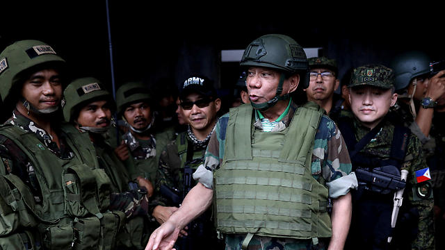 עדויות: הגופה הושלכה כמאכל לתנין. נשיא הפיליפינים במדי צבאו (צילום: רויטרס) (צילום: רויטרס)