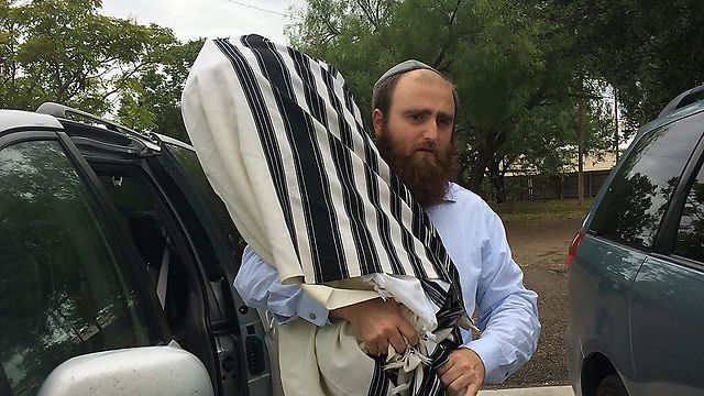 A Torah scroll is removed from the Houston Chabad House (Photo: Chabad.org)
