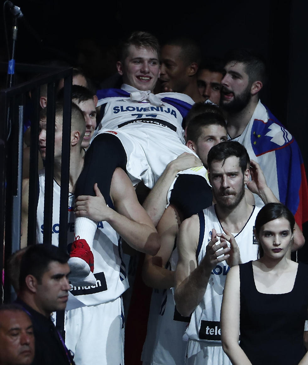 החברים בסלובניה מניפים את דונצ'יץ'. יריית פתיחה לקריירת NBA (צילום: רויטרס) (צילום: רויטרס)