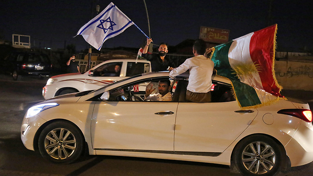 Kurds wave Israeli flags (Photo: AFP)