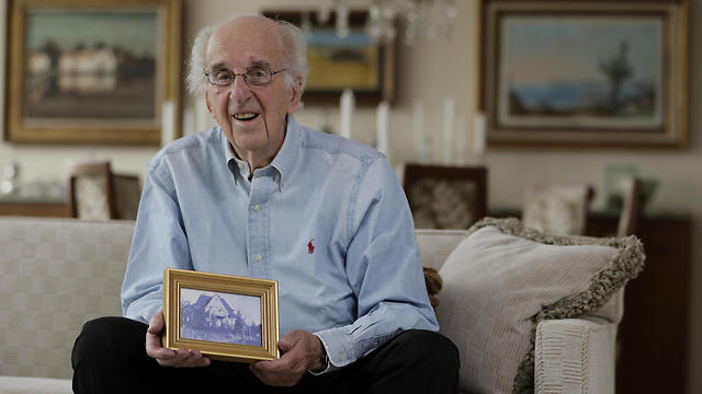 Peter Hirschmann, holding a picture of his family's home (Photo: AP)
