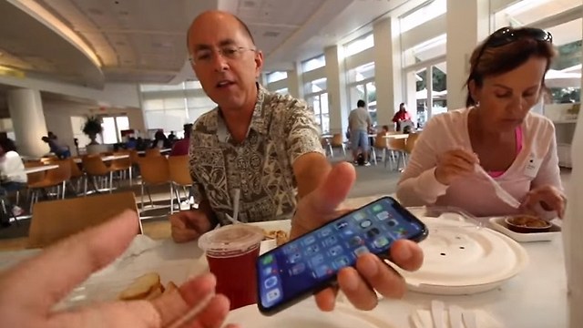 האב מגיש את האייפון לבתו (צילום מסך) (צילום מסך)