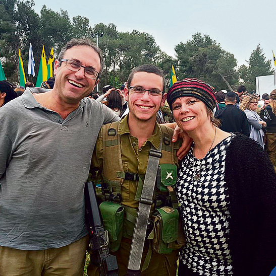 Elchai Teharlev (center), murdered in the Ofra Junction terrorist attack, and his parents