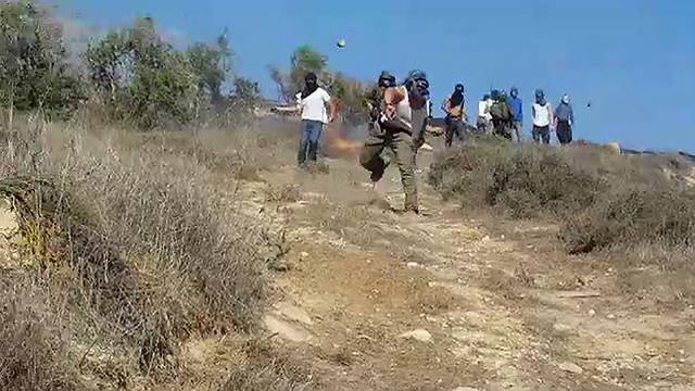Footage captures IDF soldiers standing idly by as settlers threw rocks at Palestinians (Photo: Zacharia Sadeh, Rabbis for Human Rights)